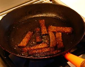 Kepta duona frying in a pan.