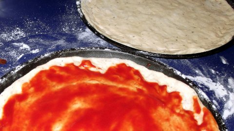 Pizza bases, one plain and one with passata.