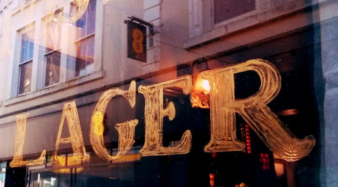 Lager written on a pub window.