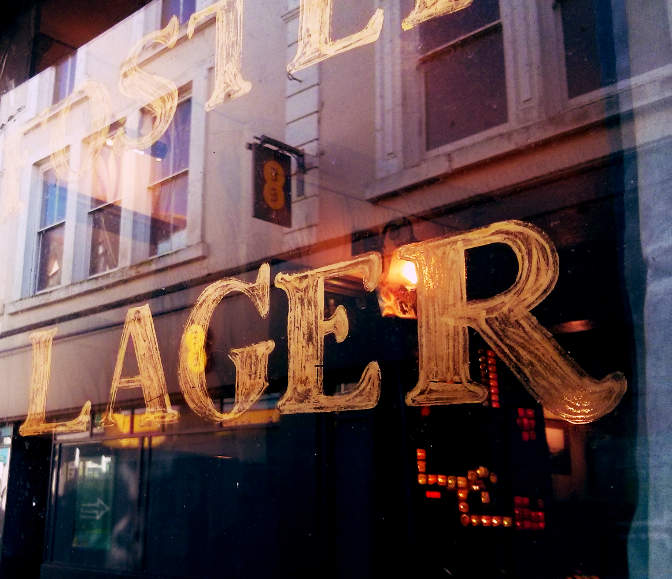 Lager written on a pub window.
