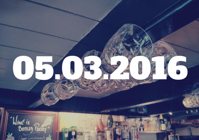 05.03.2016 -- pint glasses hanging behind the bar of a pub.