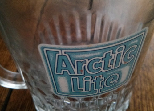 Logo on an Arctic Lite beer glass.
