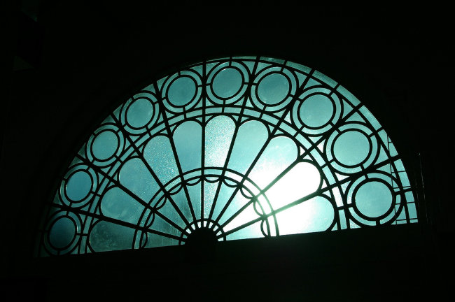 Blue stained window in silhouette.