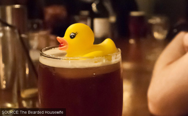 A rubber duck in a pint of beer.