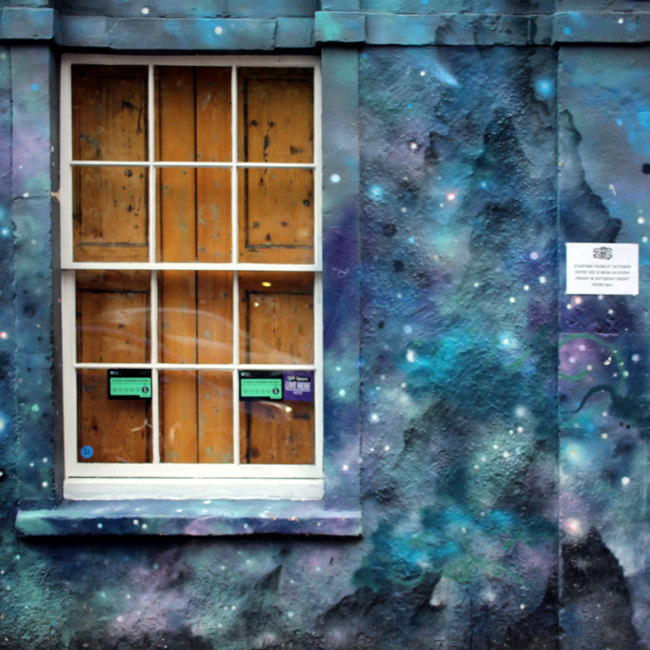 A window surrounded by painted stars.