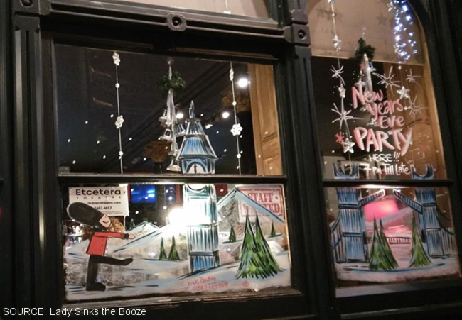 A pub window decorated for Christmas.