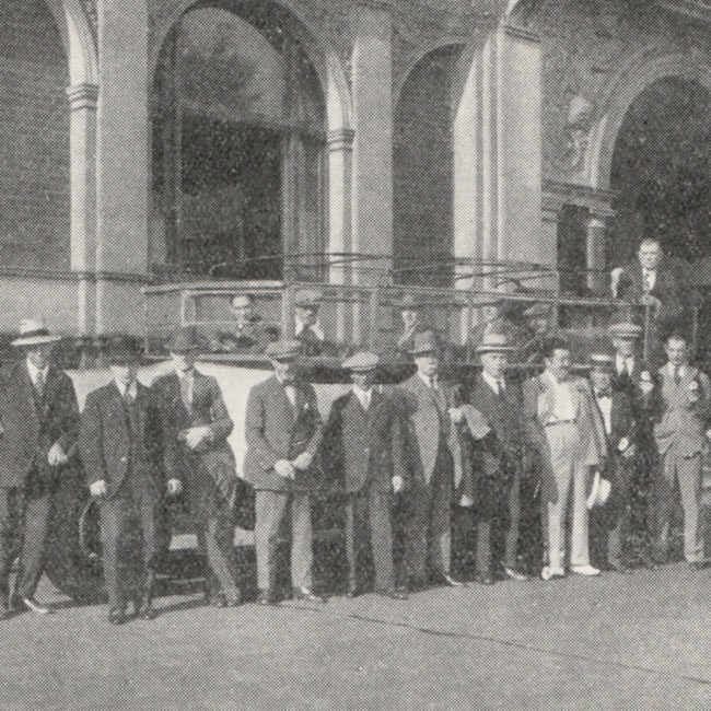 Men in front of a charabanc.