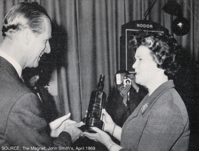 The Duke of Edinburgh presenting Mrs Land with her trophy.