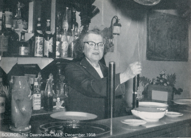 A woman behind the beer pumps.
