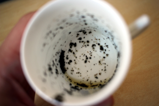 Reading tea leaves in a cup.