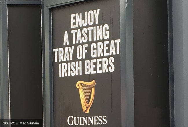 Pub sign advertising a tasting tray of Irish beers.