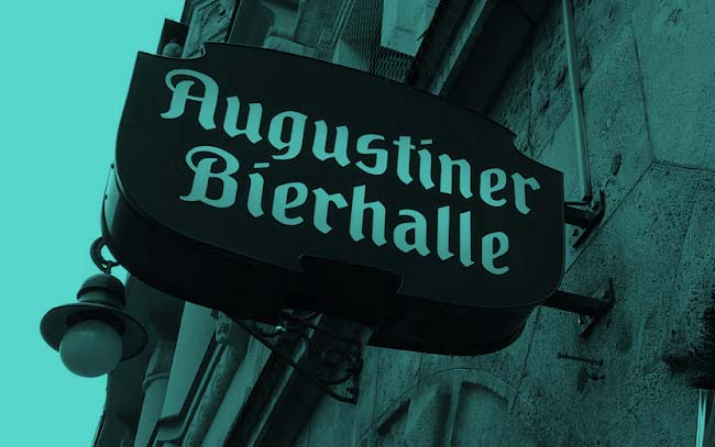 A sign on a building advertising an Augustiner Bierhalle (Augustiner Beer Hall).