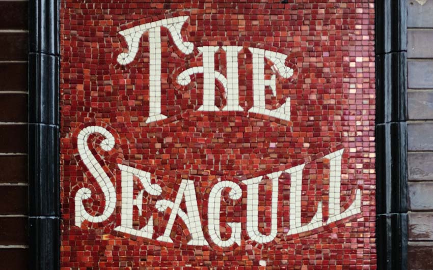 A close-up of the mosaic sign for The Seagull.