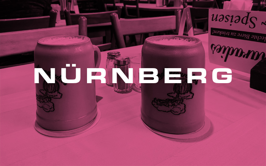 Two beer mugs with the text Nuernberg overlaid.