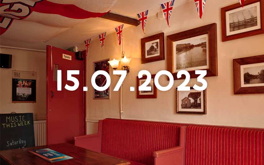 The interior of The Red Lion a Mangotsfield with framed pictures and flags.
