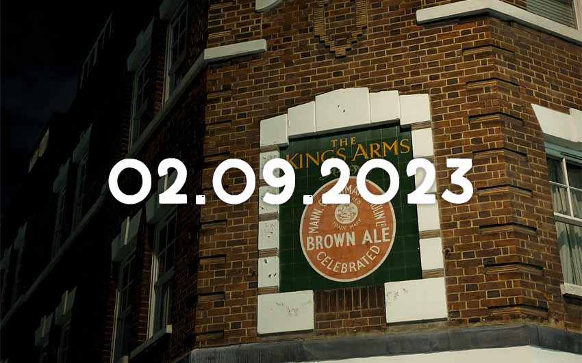 A sign on a former pub building advertising Mann's Brown Ale.