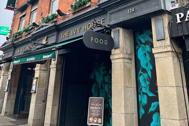 The exterior of the Ivy House, a grand-looking pub advertising food and brunches.